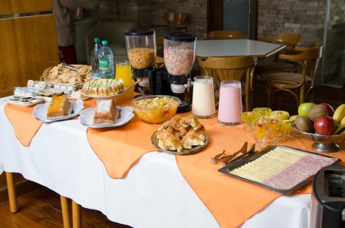 a table filled with food and other foods on it at Hotel Dior in Tandil