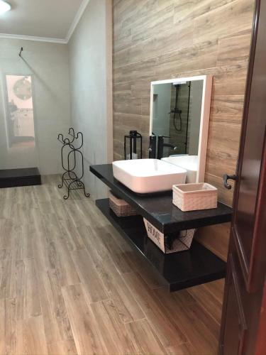 a bathroom with a sink and a large mirror at Rustic Villa with Private Pool near Ericeira in Mafra