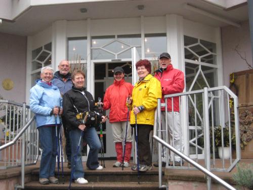 a group of people standing on the steps of a house at Castell Hotel & Restaurant in Leinsweiler