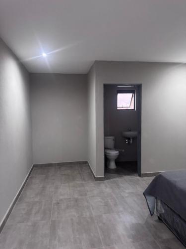 an empty room with a toilet and a window at The Gardens view lodge in Bushbuckridge