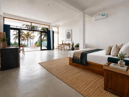 a bedroom with a bed and a living room at Chez Colette in Matara