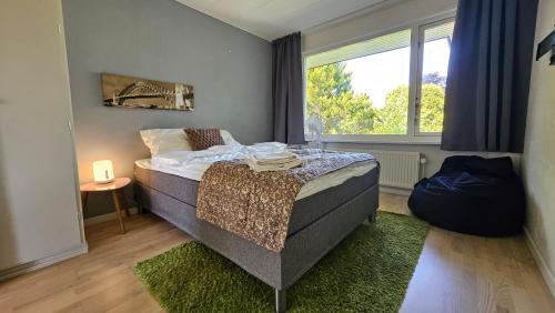 a bedroom with a bed and a large window at Modern, spacious villa with Sauna in Ruds-Vedby