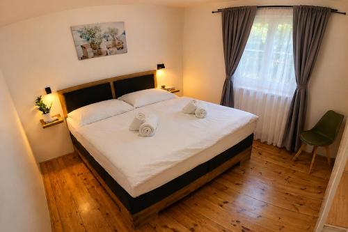 a bedroom with a bed with two towels on it at Apartmány Lipno 46 in Lipno nad Vltavou