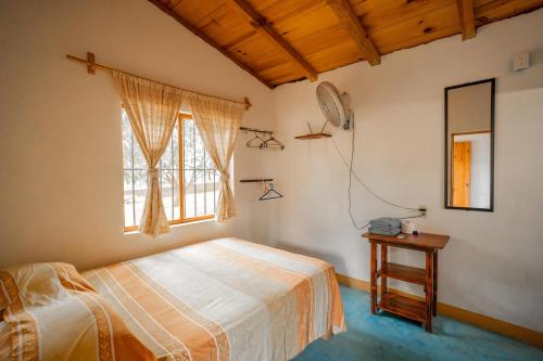 a bedroom with a bed and a window at Casa Mahue in Puerto Escondido