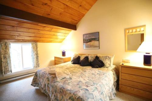 a bedroom with a bed and a large window at Sunnyside 6 in Condo Waterville Valley in Waterville Valley