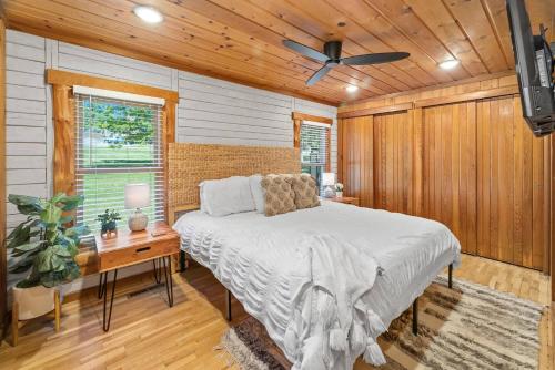 a bedroom with a bed and a desk and a ceiling fan at Serenity - 60 Ridge Lane in Branson