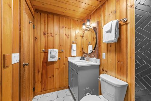 a bathroom with a toilet and a sink at Serenity - 60 Ridge Lane in Branson