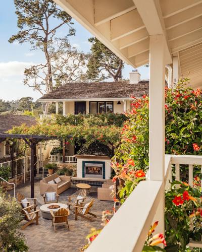 a patio with a fireplace on a house at Hotel Carmel in Carmel