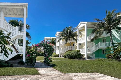 a building with palm trees and flowers in front of it at Westgate Bimini Bay in Bailey Town