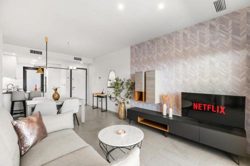a living room with a couch and a fireplace at Skyline Infinity Apartment Eagle Tower Benidorm in Benidorm