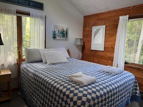 a bedroom with a bed with two towels on it at Goose Hollow 19 Estates Pet Friendly Private Waterfront Home in Campton