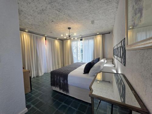 a hotel room with a bed and a window at Stipa Boutique Hotel in Chacras de Coria