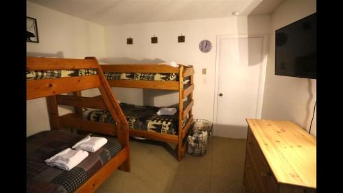 a room with three bunk beds and a table at Windsor Hill E53 WV Updated Pet Friendly Windsor Hill Condo in Waterville Valley