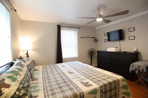 a bedroom with a bed and a flat screen tv at Bog Road 76 Campton Cozy Private Single Family Home in Campton in Campton