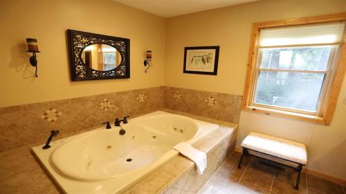 a large bathroom with a tub and a window at Welch View 41 Thornton Private Home Close to Waterville Valley in Thornton