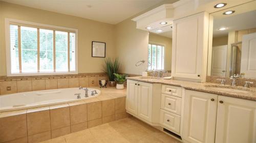 a large bathroom with a tub and a sink at Rising Ridge 28 Owls Nest Deluxe Pet friendly Home at Owl`s Nest in Campton