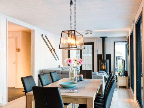 a dining room and living room with a table and chairs at 4 star holiday home in Øyer in Øyer
