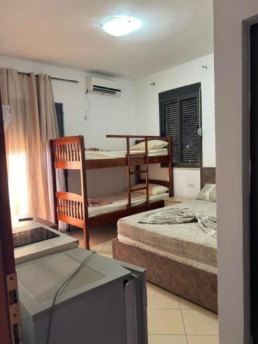 a living room with two beds and a television at Vila Mare in Shëngjin