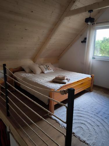 a bedroom with a bed in a attic at Siedlisko Niwy in Łęki Szlacheckie
