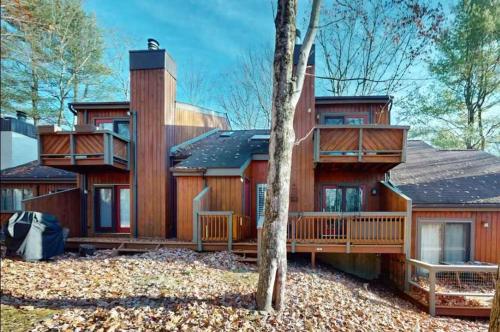 a large wooden house with a large deck at 103 Ruffed Grouse Ct in Lake Harmony