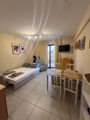 a living room with a bed and a table at Thalassa Home A in Chiliadou