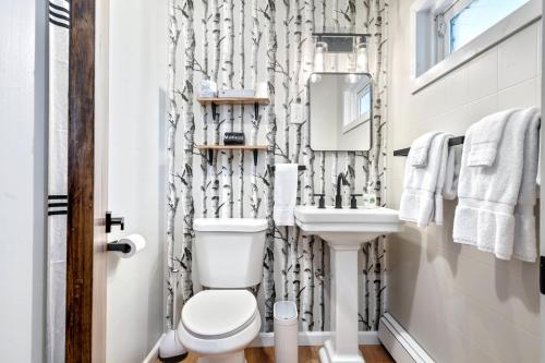 a bathroom with a toilet and a sink at The Inn at the Rostay in Bethel