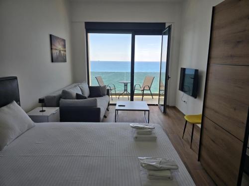 a bedroom with a bed and a view of the ocean at Hotel Sutomore & Apartments in Sutomore