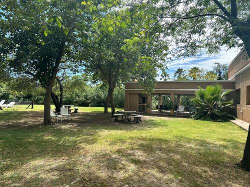 a building with a picnic table in a yard at Casa Casona Las Toscas in Miramar