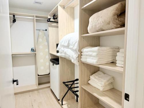 a room with a closet filled with towels at Chic Luxury 1BR Oasis in Miami