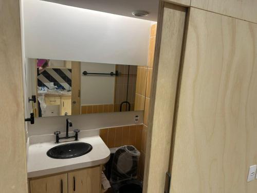 a bathroom with a sink and a mirror at U House in São Paulo