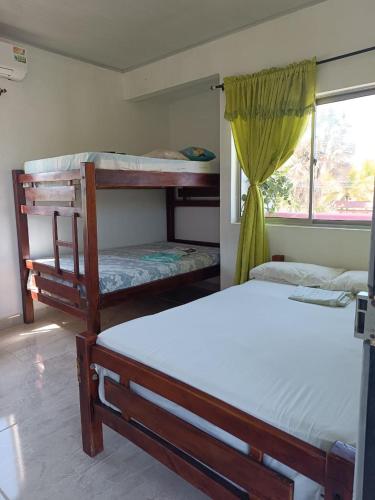 a bedroom with two bunk beds and a window at Alojamiento Matuzalen in Coveñas