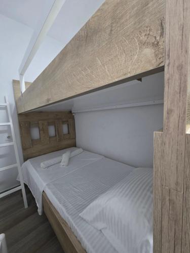 a bedroom with a bunk bed with a ladder at Solei Sea Apartment in Shëngjin