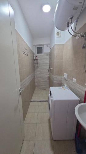 a bathroom with a shower and a toilet and a sink at Solei Sea Apartment in Shëngjin