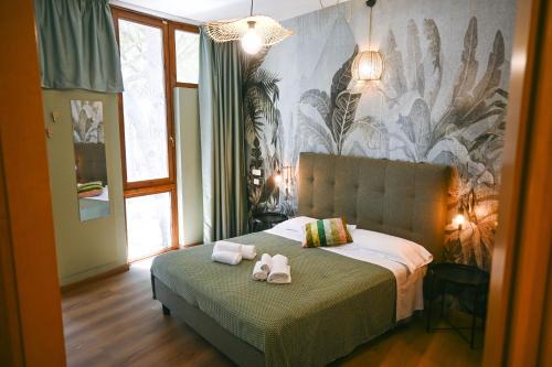 a bedroom with two stuffed animals on a bed at CSA Hotel Beach & Park in Marina di Bibbona