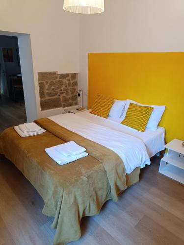 a large bed with two towels on top of it at Castle apartment Aga in Uzzano
