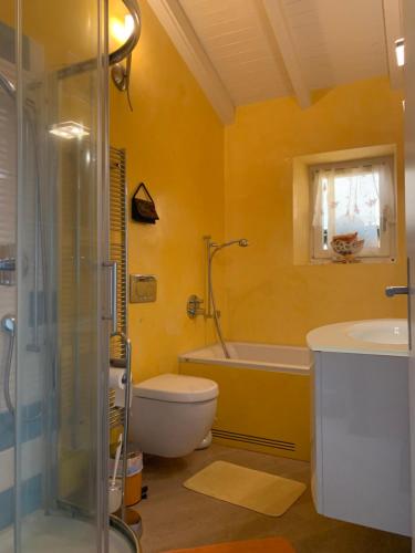 a bathroom with a tub and a toilet and a sink at Ferienhaus, Rustico Auf Burg in Locarno