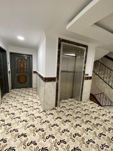 a room with a staircase with a door and a carpet at Bani motel in Duhok