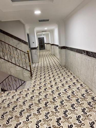 a hallway with a tiled floor in a building at Bani motel in Duhok