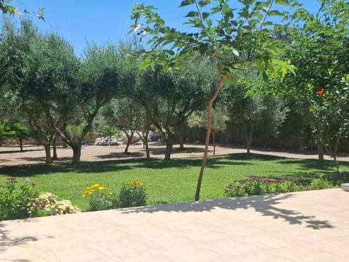 a park with trees and green grass and flowers at Rhodes Soul Luxury Home in Asgourou