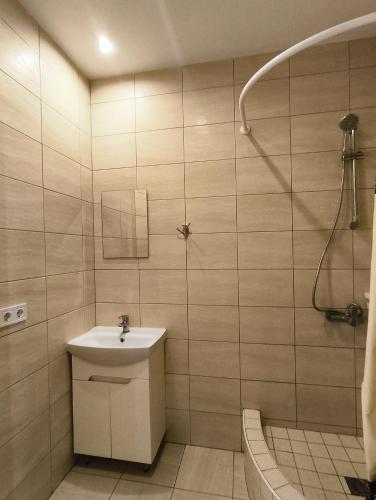 a bathroom with a sink and a shower at Guest House Dacha in Karolino-Buhaz