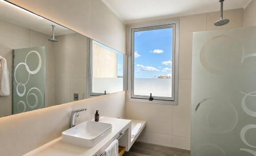 a bathroom with a sink and a window at Pinamar Beach Resort in Pinamar