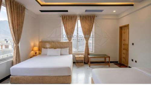 a bedroom with two beds and a window at Diamond Hills Resort in Battakundi