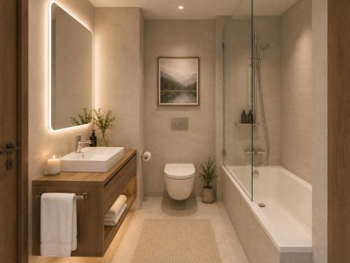 a bathroom with a sink and a toilet and a tub at KM Rentals - Lillestrøm City Centre - Selected Hotels in Lillestrøm