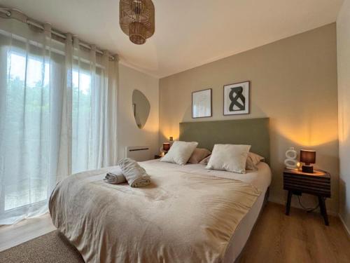 a bedroom with a large bed and a window at Premium surf lodge in Capbreton