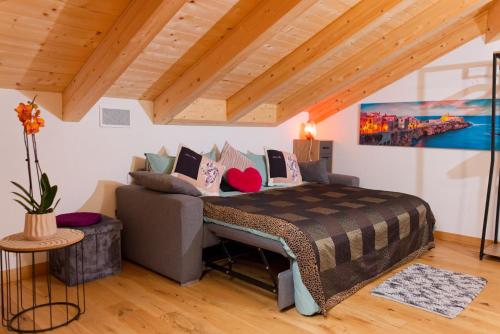 a bedroom with a bed and a couch in a room at LoSteLaDa sul lago di Como in Colico