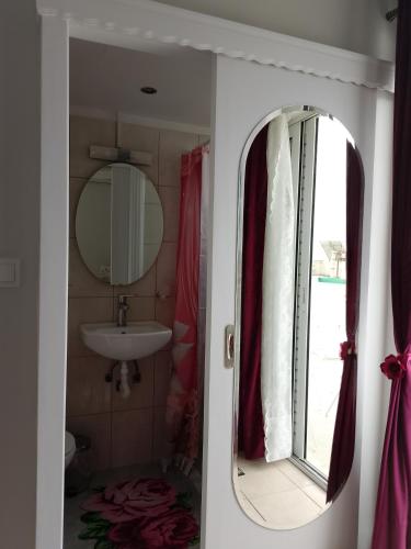 a bathroom with a sink and a mirror at Heavenly joy in Patra