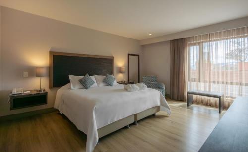 Un pat sau paturi într-o cameră la Hotel Morrison Zona T