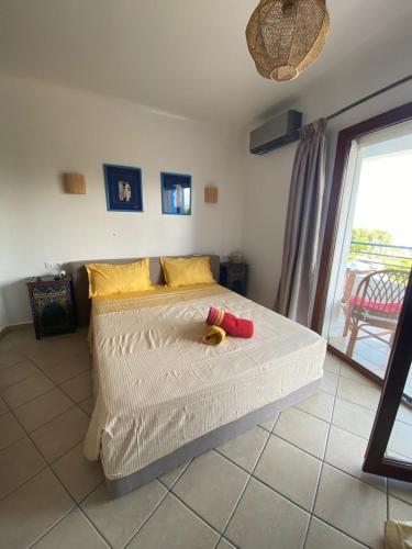 a bedroom with a bed with two stuffed animals on it at Appart hôtel Cabo dream in Cabo Negro