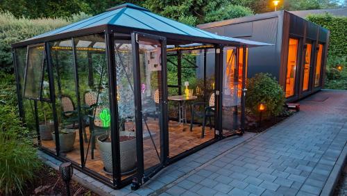 a greenhouse with a blue roof on a patio at BayVista Lodge - Studios & Apartments in Lam