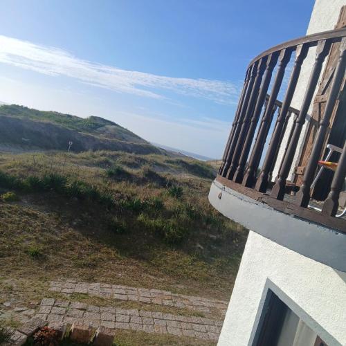 a balcony of a building with a view of a hill at Paraíso Chuí in Santa Vitória do Palmar